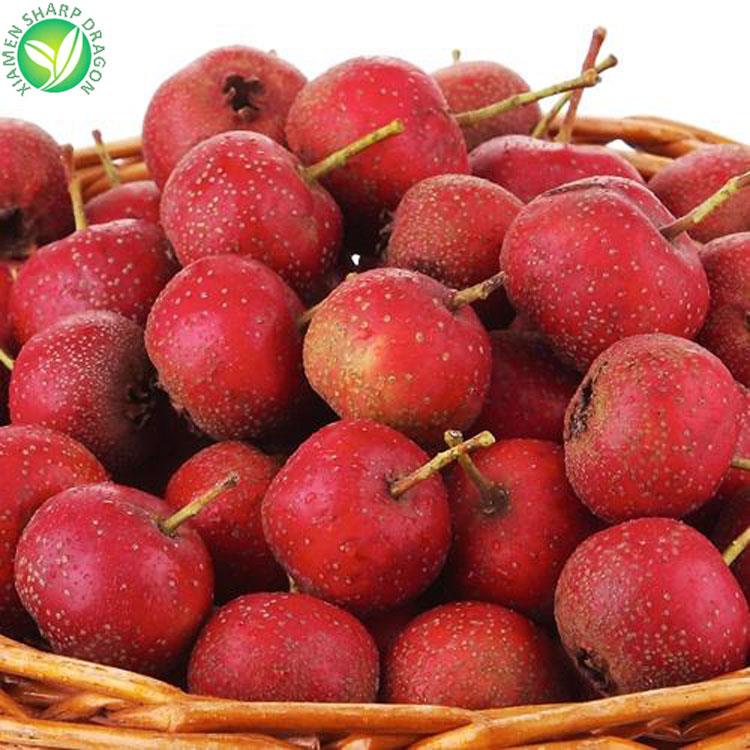 Whole hawthorn fruit displayed in a woven basket Whole red hawthorn fruit displayed in a woven basket